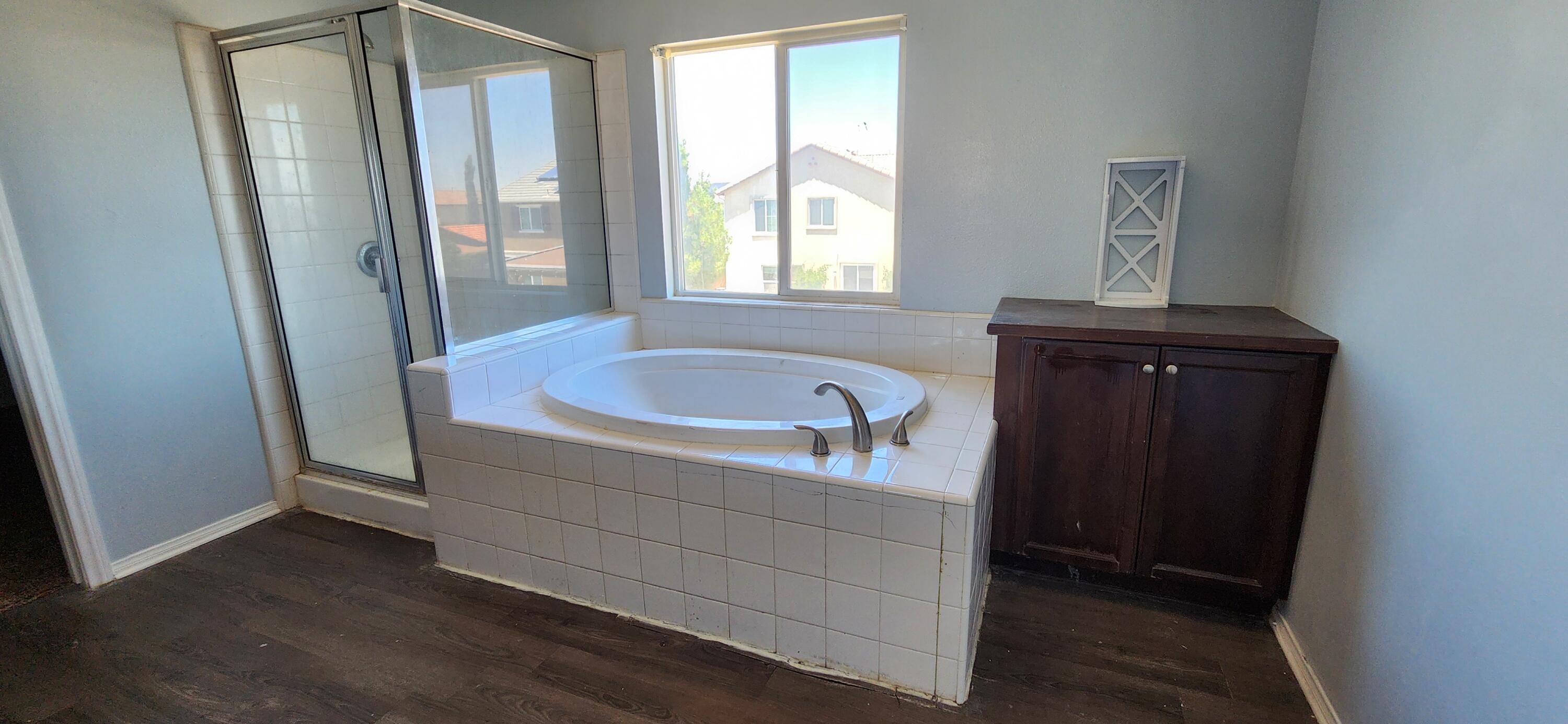 5817 Gem Court Lancaster, CA 93536 - Photo 23 of 26 a bathroom with a tub sink and mirror