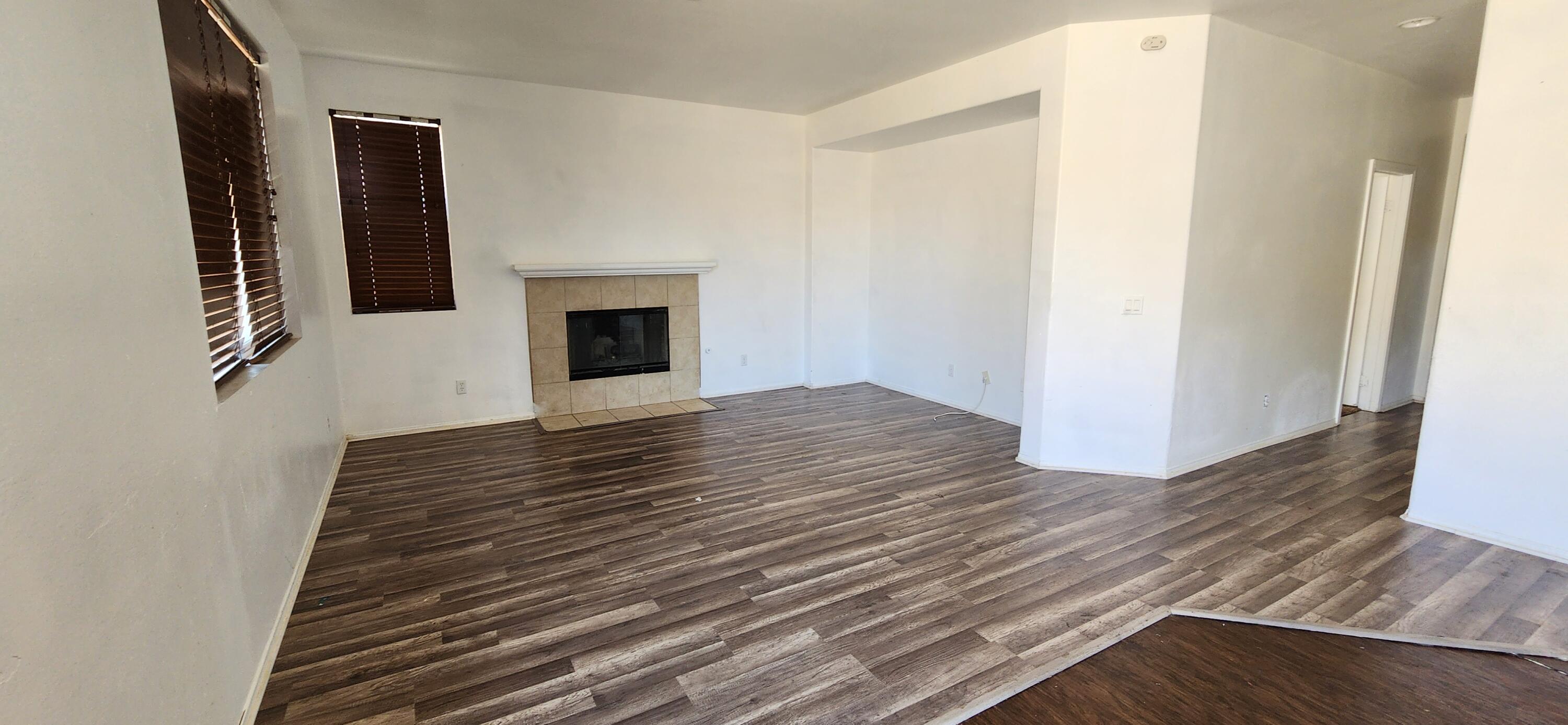 5817 Gem Court Lancaster, CA 93536 - Photo 7 of 26 a view of a hallway with wooden floor and staircase