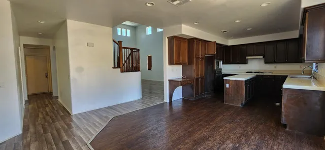 a kitchen with kitchen island a refrigerator stove and microwave