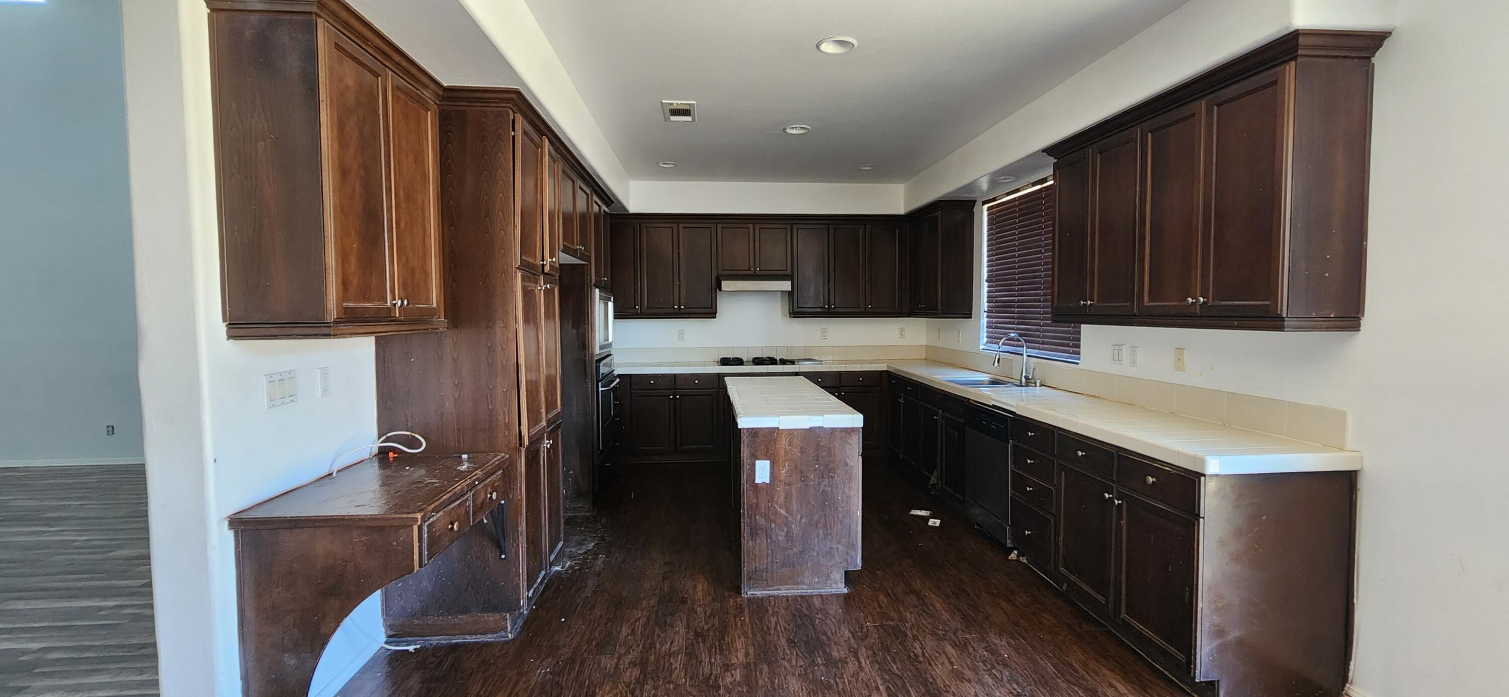 5817 Gem Court Lancaster, CA 93536 - Photo 9 of 26 a kitchen with a sink cabinets and wooden floor