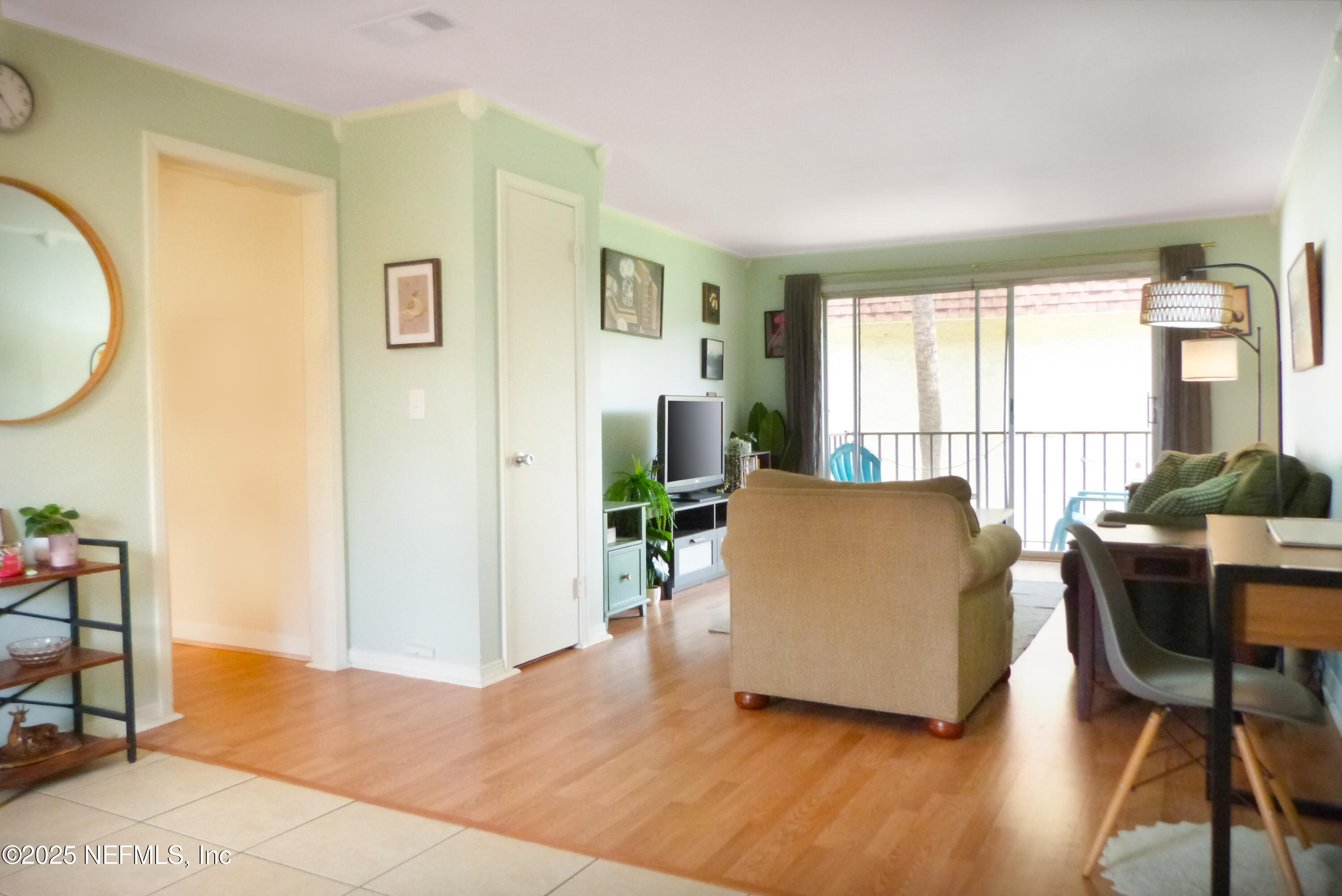 7341 El Ocho Road, Unit 5 Jacksonville, FL 32216 - Photo 2 of 9 a living room with furniture and a table