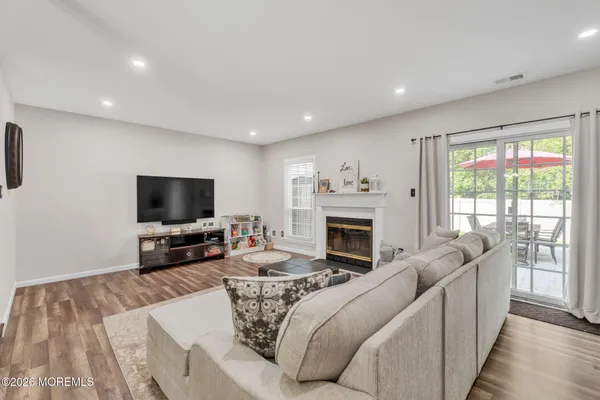 a living room with furniture a fireplace and a flat screen tv