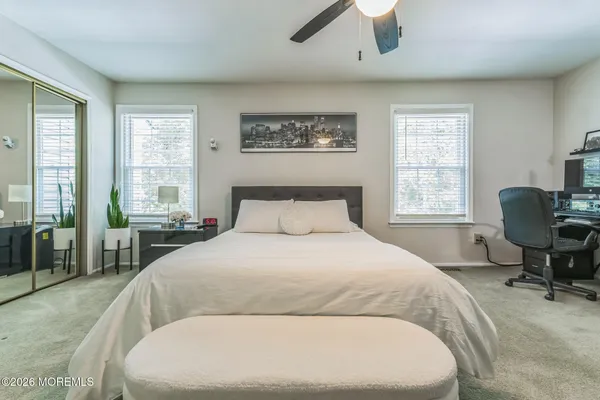 a spacious bedroom with a large bed and a large window