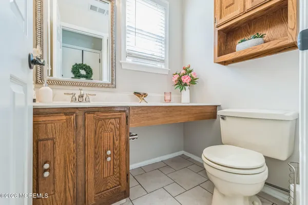 a bathroom with a sink a toilet and mirror