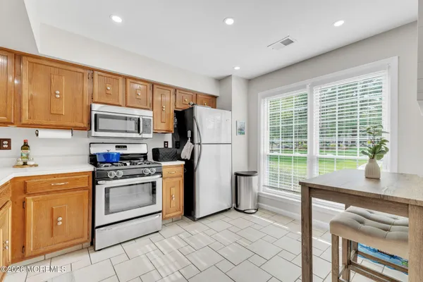 a kitchen that has a refrigerator and a stove top oven