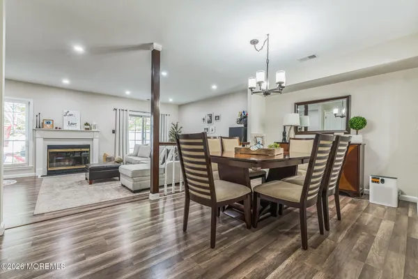 a view of a dining room with furniture wooden floor and chandelier
