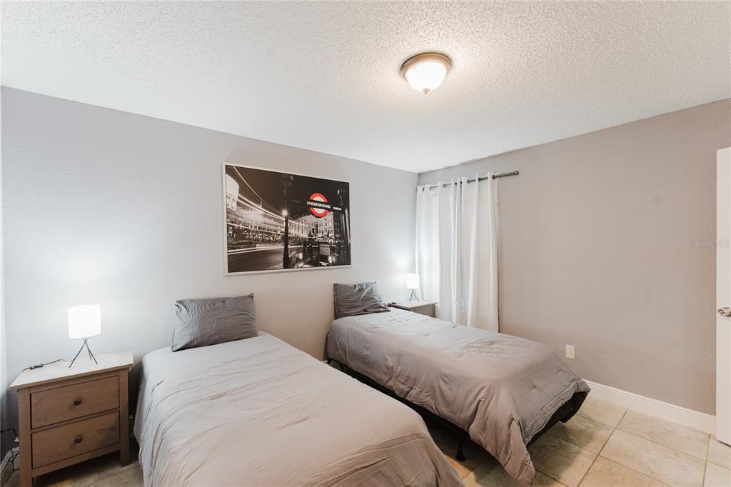 5120 Conroy Road, Unit 18 Orlando, FL 32811 - Photo 15 of 38 a bedroom with two bed and a tv