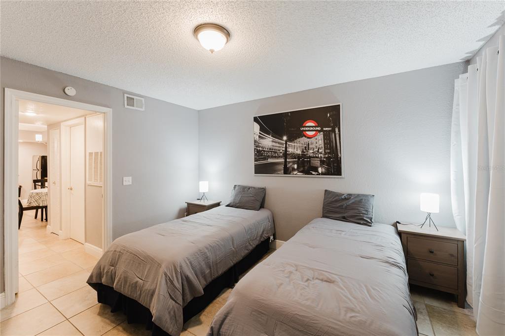 5120 Conroy Road, Unit 18 Orlando, FL 32811 - Photo 16 of 38 a bedroom with two beds and a flat screen tv