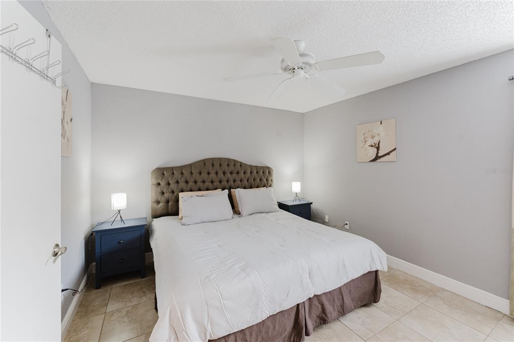 5120 Conroy Road, Unit 18 Orlando, FL 32811 - Photo 21 of 38 a bedroom with a bed and a night stand