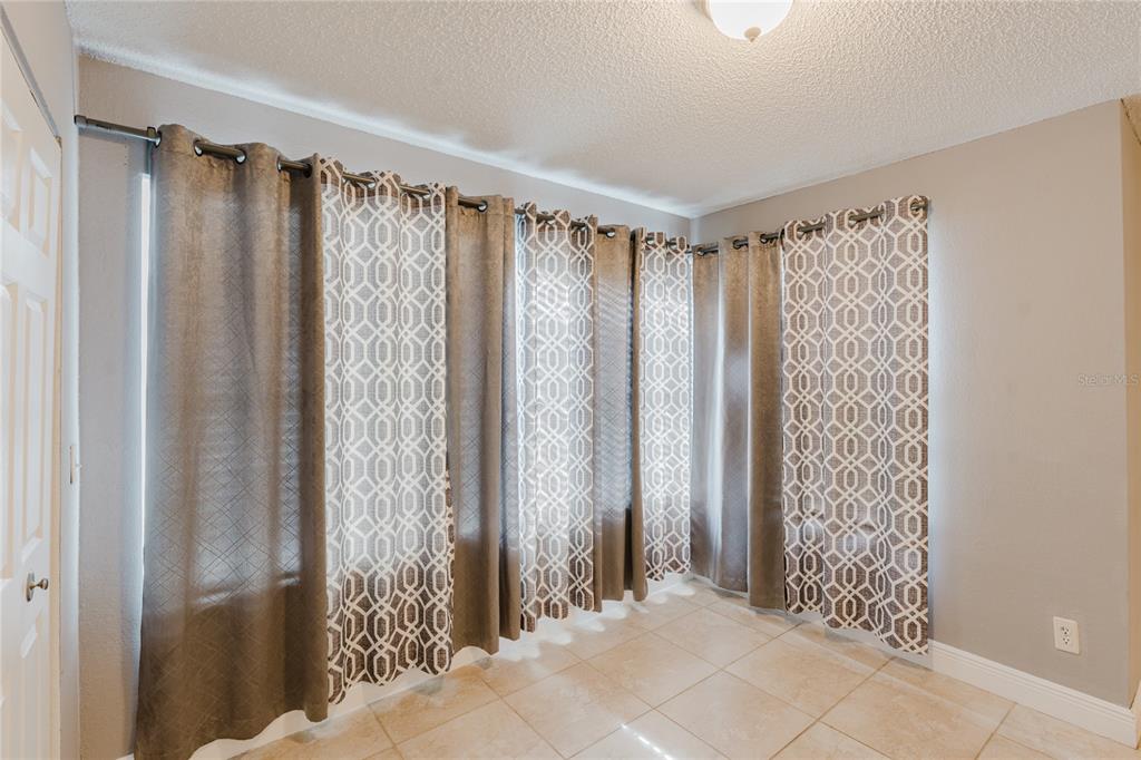 5120 Conroy Road, Unit 18 Orlando, FL 32811 - Photo 7 of 38 a view of a bathroom with a shower and a curtain