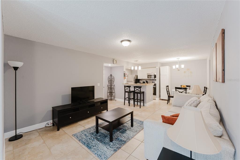 5120 Conroy Road, Unit 18 Orlando, FL 32811 - Photo 8 of 38 a living room with furniture and a flat screen tv