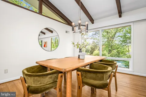 a view of a dining room with furniture and a window