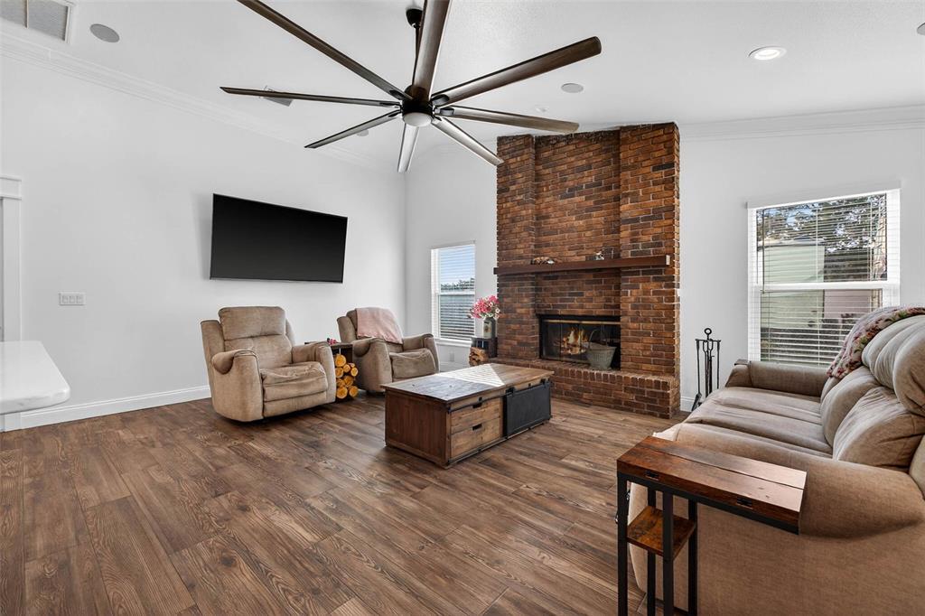 11945 74th Avenue Seminole, FL 33772 - Photo 12 of 47 a living room with furniture a flat screen tv and a fireplace