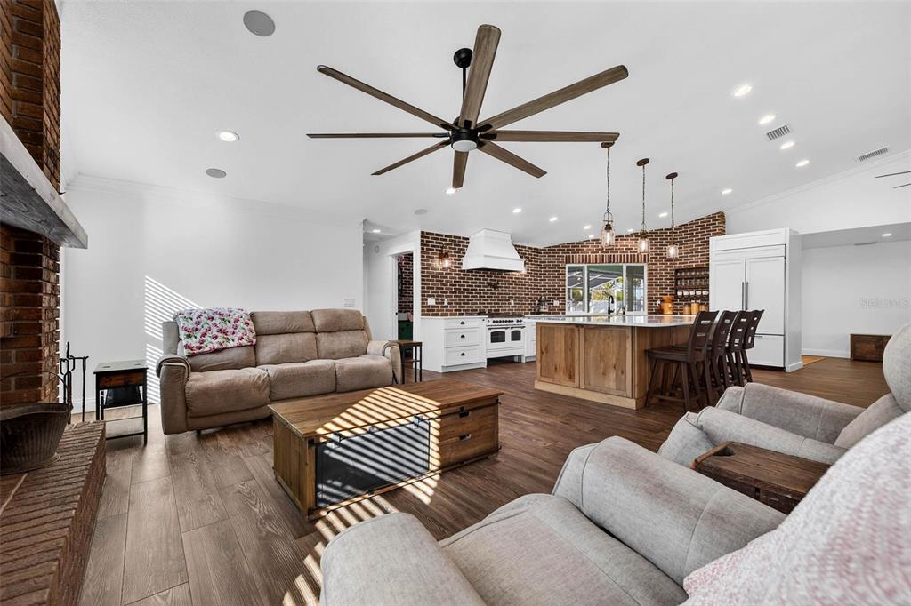 11945 74th Avenue Seminole, FL 33772 - Photo 13 of 47 a living room with furniture kitchen view and a wooden floor