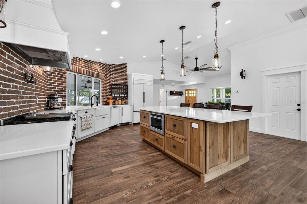 11945 74th Avenue Seminole, FL 33772 - Photo 19 of 47 a kitchen with stainless steel appliances granite countertop a stove and a wooden floors