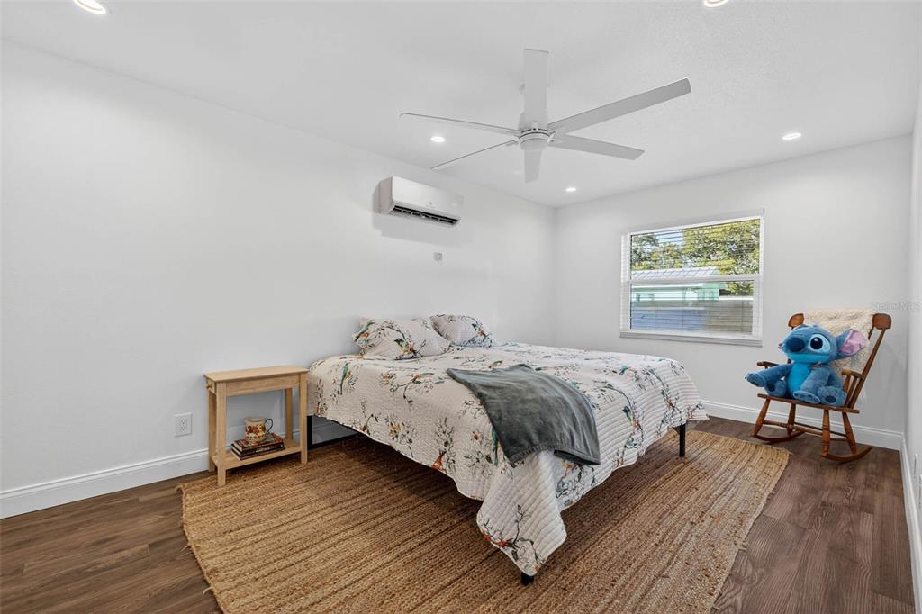 11945 74th Avenue Seminole, FL 33772 - Photo 26 of 47 a bed room with a bed and a chair