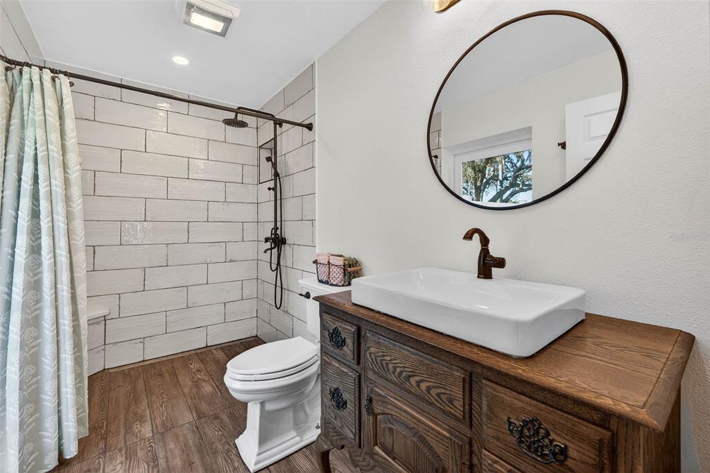 11945 74th Avenue Seminole, FL 33772 - Photo 28 of 47 a bathroom with a sink a toilet and a mirror