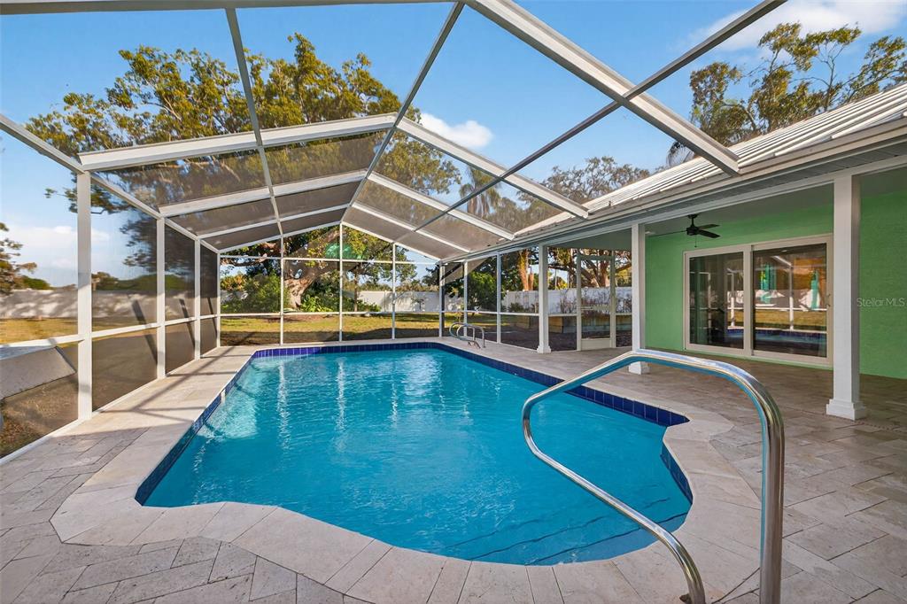 11945 74th Avenue Seminole, FL 33772 - Photo 35 of 47 a view of a swimming pool with a patio