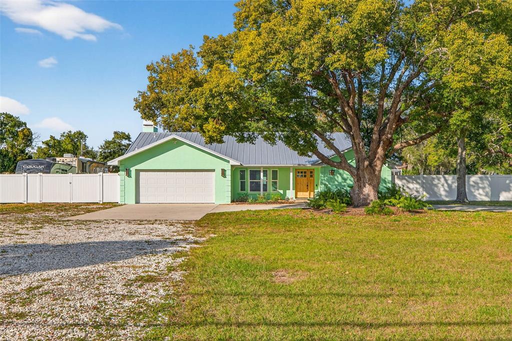 11945 74th Avenue Seminole, FL 33772 - Photo 5 of 47 a front view of a house with a yard and trees
