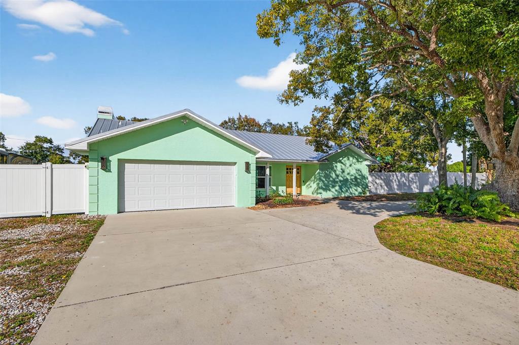 11945 74th Avenue Seminole, FL 33772 - Photo 7 of 47 a front view of a house with a garden and porch
