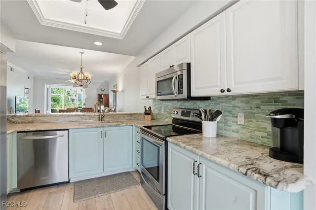a kitchen with stainless steel appliances granite countertop a sink stove and cabinets