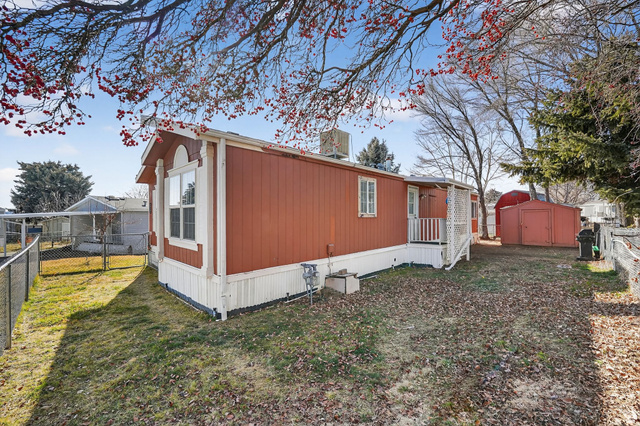 269 Mindella Way, Unit A Layton, UT 84041 - Photo 22 of 37 View of side of home with a storage shed and a cooling unit