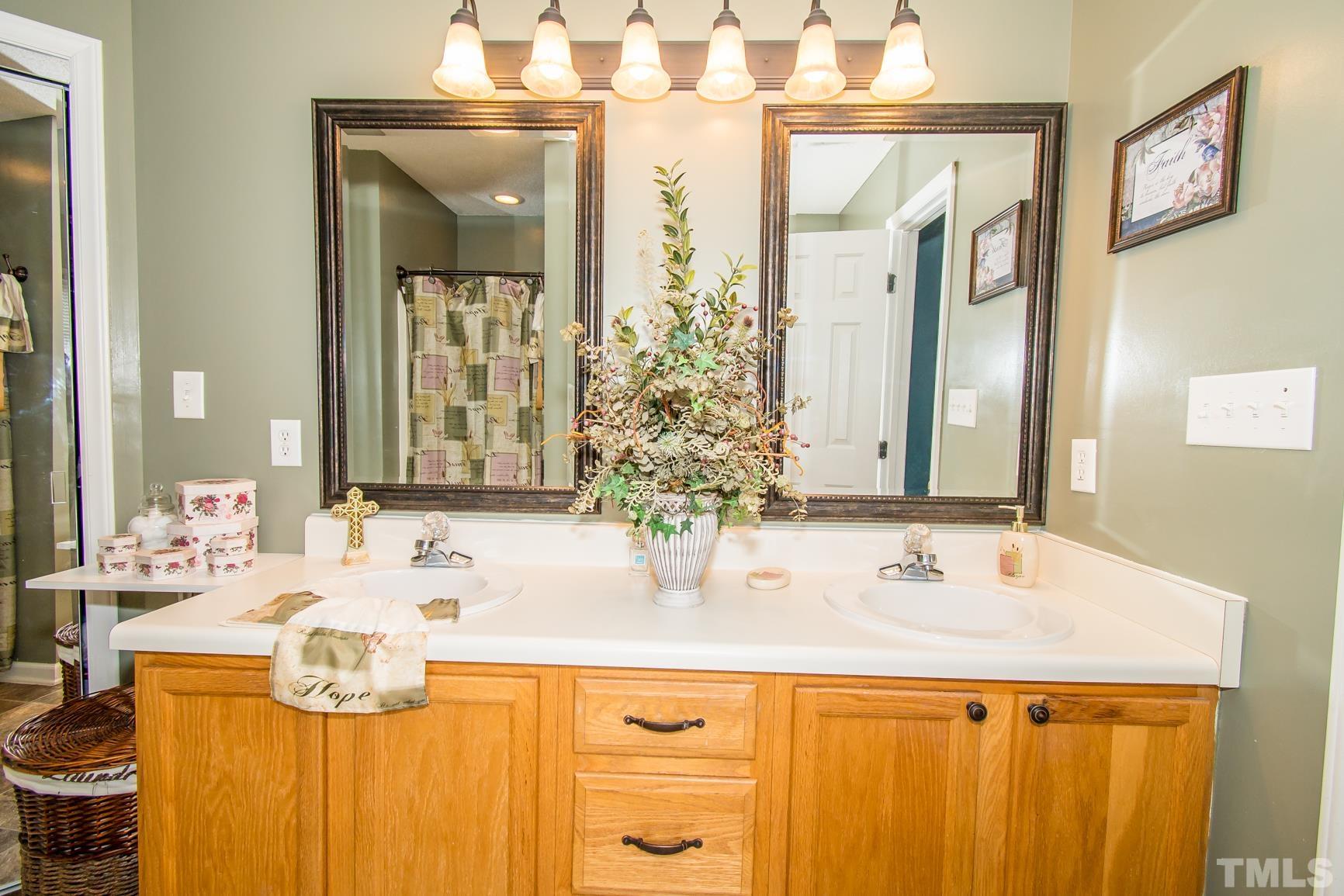 561 Yellow Berry Run Wendell, NC 27591 - Photo 11 of 27 a bathroom with a sink and a mirror