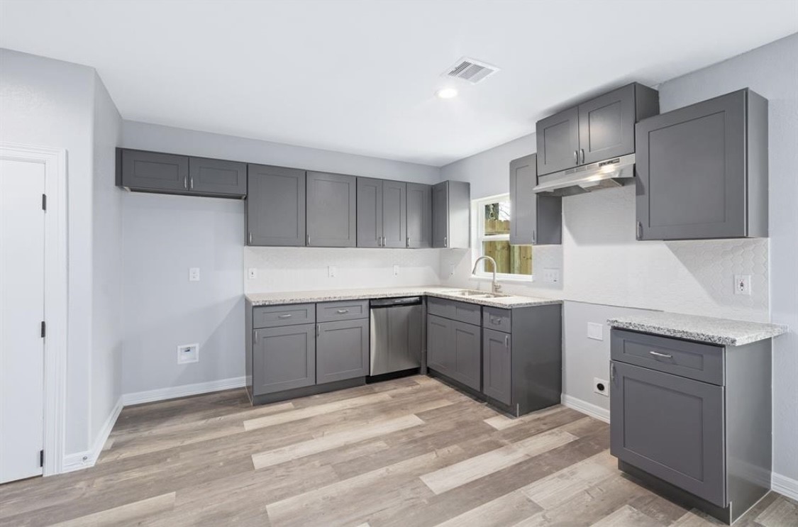 6614 Haight Street, Unit B Houston, TX 77028 - Photo 3 of 10 a kitchen with a sink stove and refrigerator