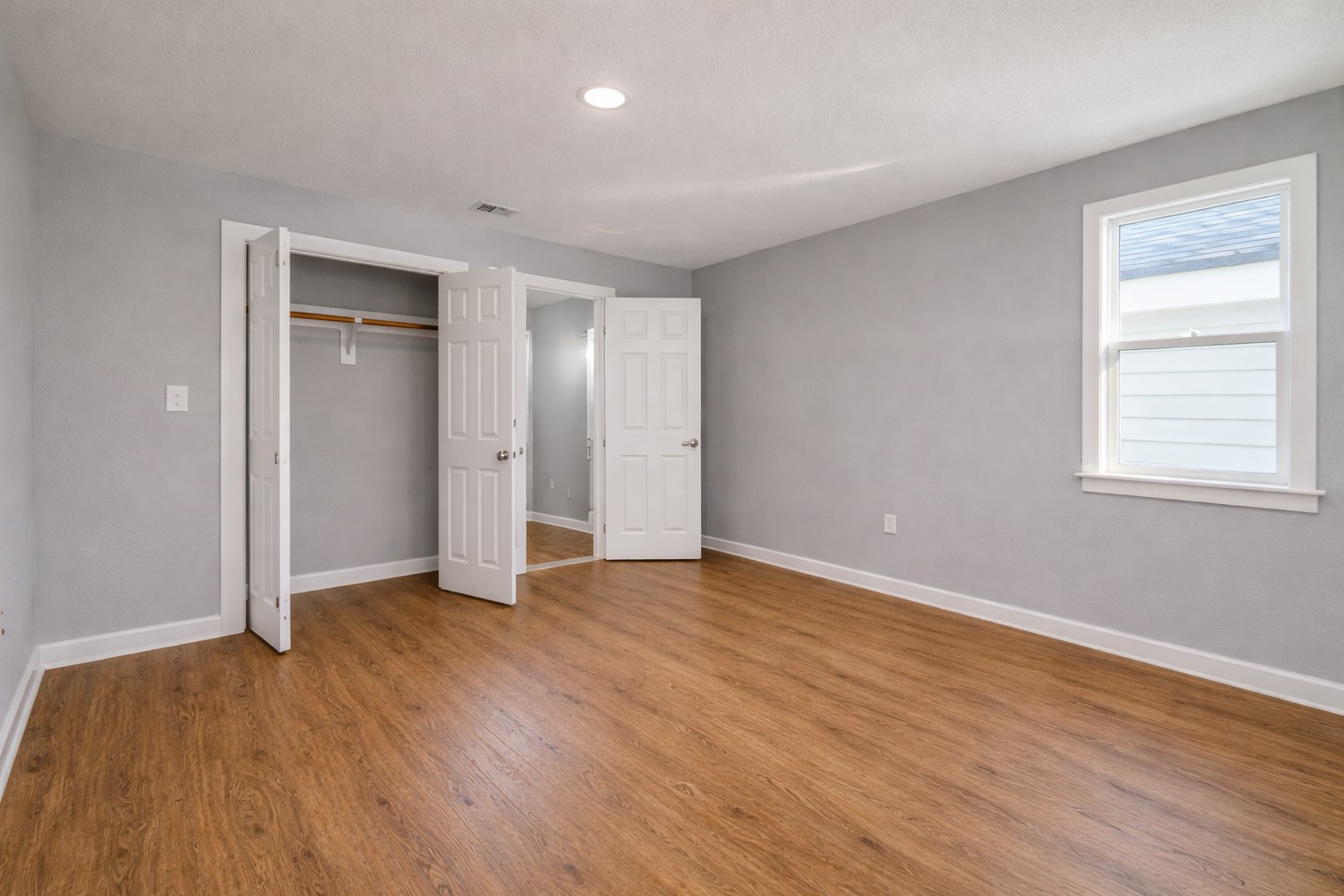 6614 Haight Street, Unit B Houston, TX 77028 - Photo 8 of 10 an empty room with wooden floor and closet