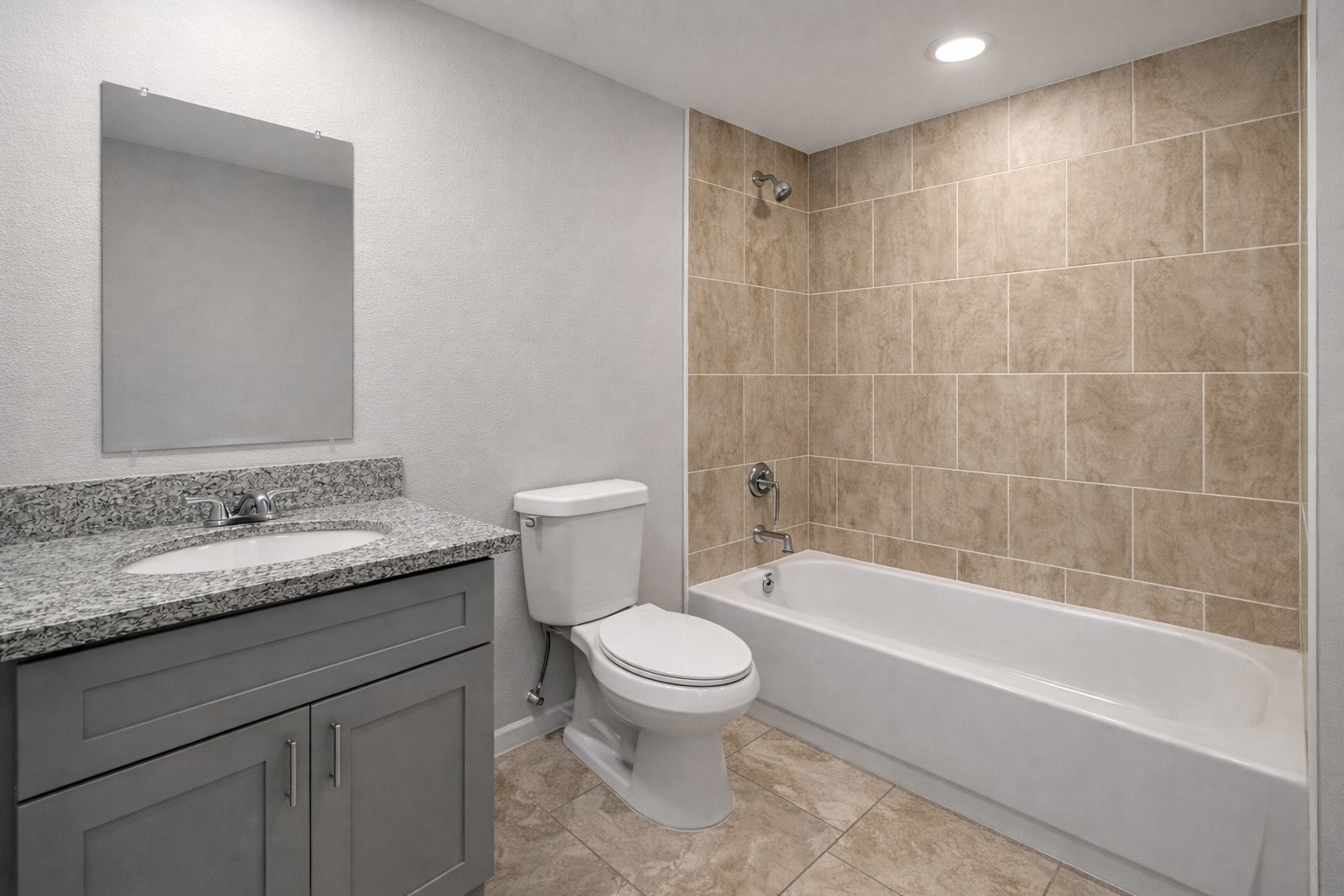 6614 Haight Street, Unit B Houston, TX 77028 - Photo 10 of 10 a bathroom with a granite countertop toilet a sink and a bathtub