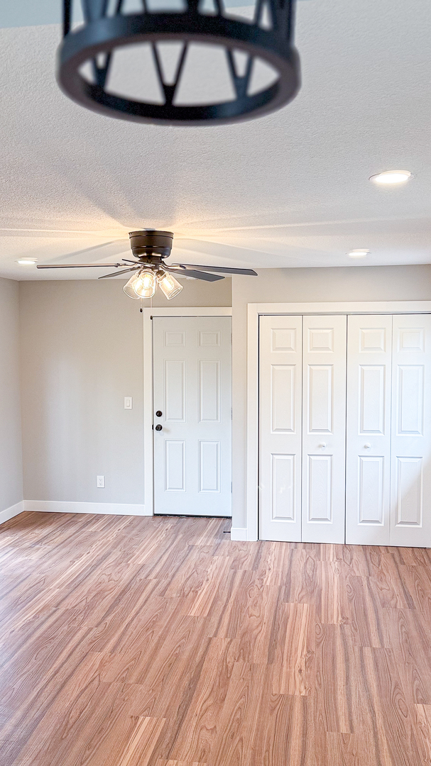 103 2nd Street Broadlands, IL 61816 - Photo 20 of 55 a view of empty room with wooden floor and fan
