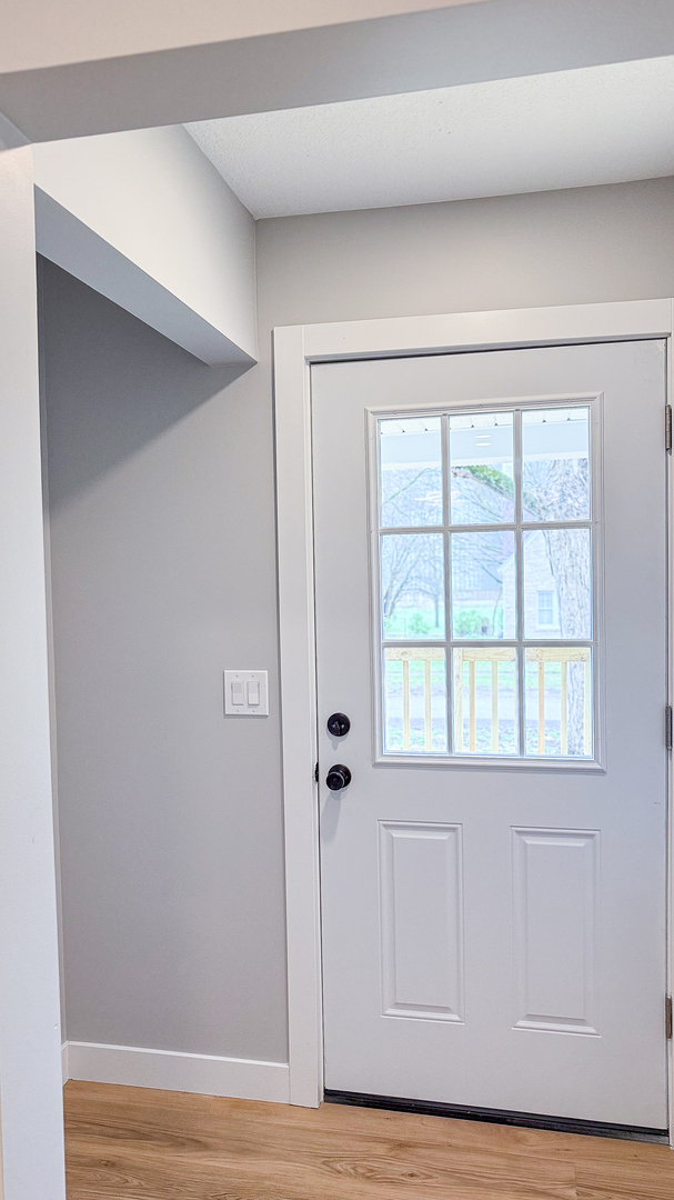 103 2nd Street Broadlands, IL 61816 - Photo 5 of 55 a view of an empty room with wooden floor and a window