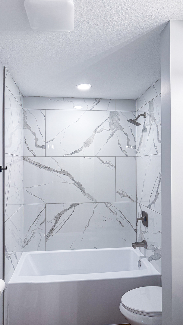 103 2nd Street Broadlands, IL 61816 - Photo 8 of 55 a bathroom with a shower and a toilet