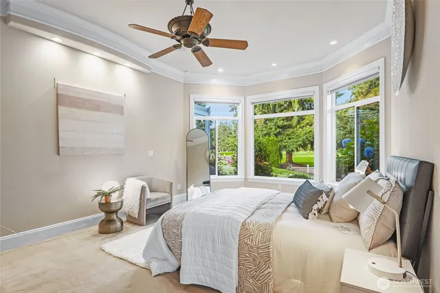 a bedroom with furniture and a large window