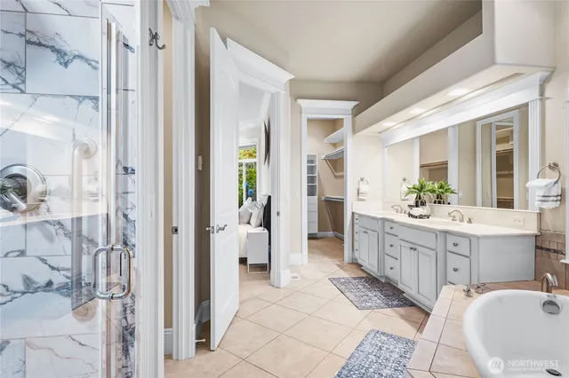 a bathroom with a double vanity sink mirror and shower