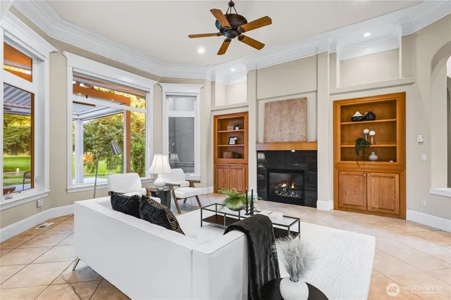 a living room with fireplace furniture and a large window