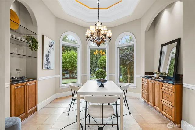 a living room with chandelier furniture and a large window