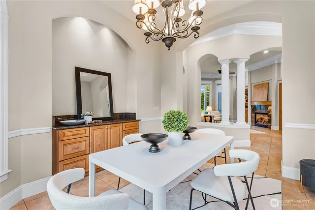 a view of a dining room with furniture and chandelier