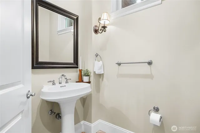 a bathroom with a sink a mirror and a toilet