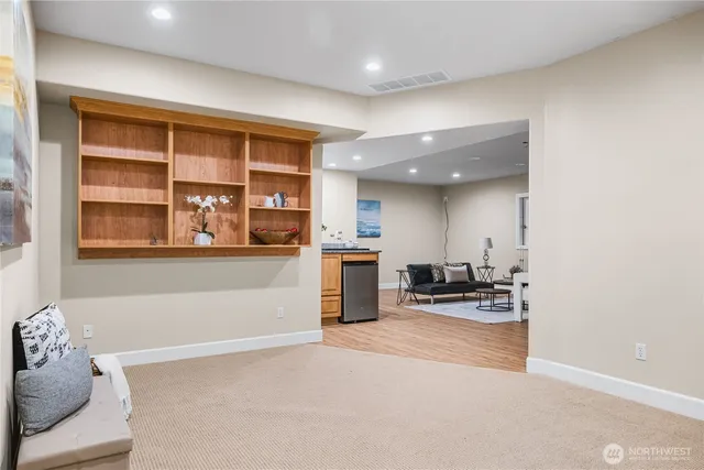 a living room with furniture and a kitchen