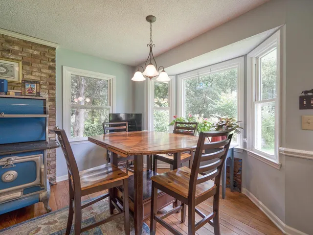 a kitchen with sink cabinets and dining area