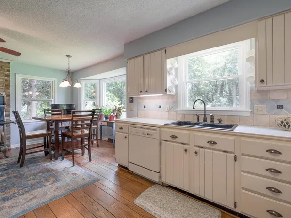 a kitchen with sink cabinets and dining table
