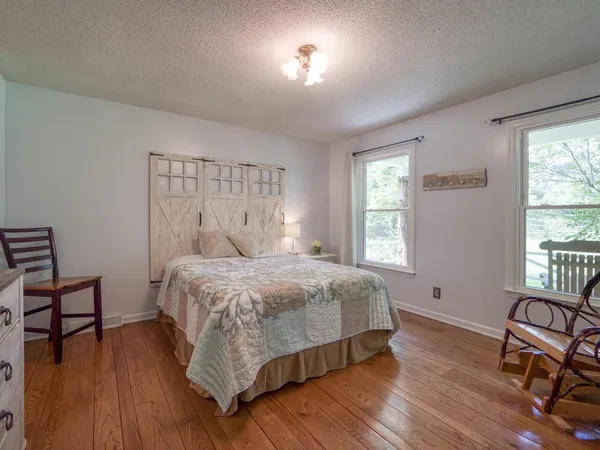a bedroom with a bed and a chair
