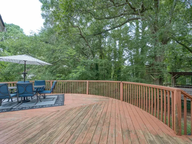 a sitting area with furniture and umbrella