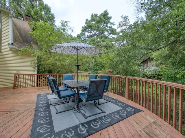 a balcony with wooden floor and fence