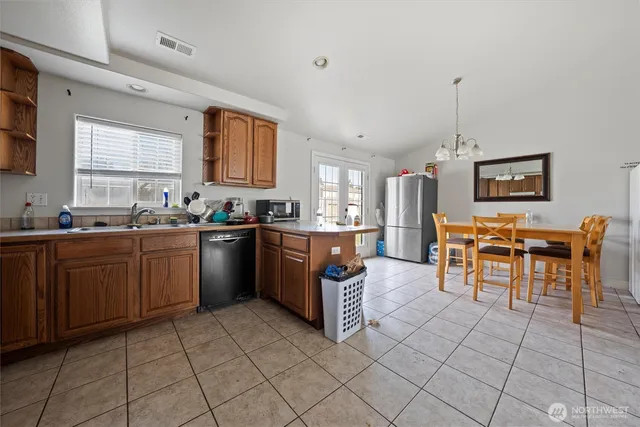 a kitchen with stainless steel appliances a sink counter space and a window