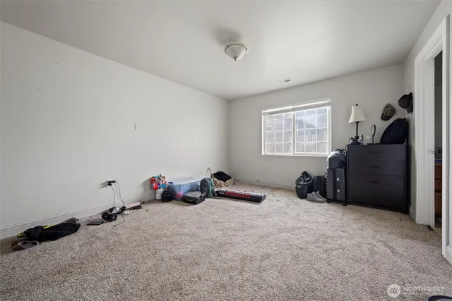 a bedroom with bed and a window