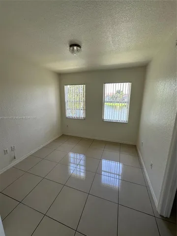 a bathroom with a granite countertop sink toilet a mirror and bathtub