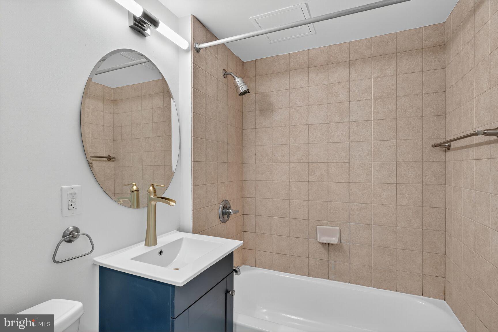 800 4th Street Southwest, Unit S221 Washington, DC 20024 - Photo 14 of 19 a bathroom with a sink toilet and shower