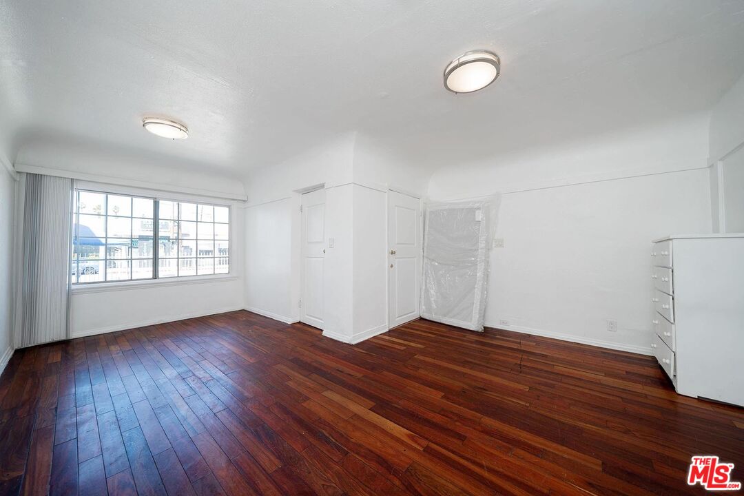3714 West Pico Boulevard Los Angeles, CA 90019 - Photo 11 of 45 a view of empty room with wooden floor and fan